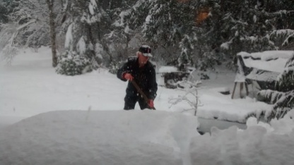 C. shoveling snow....